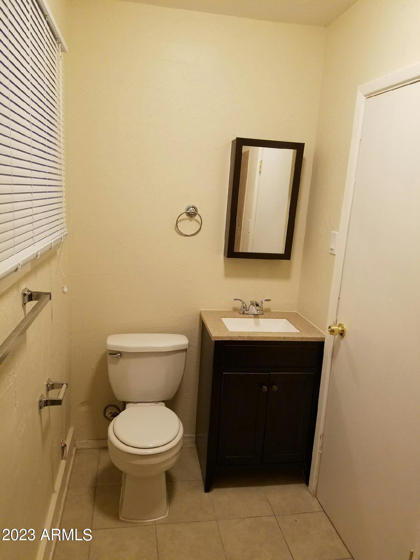 4004 East McKellips Road, Unit 1101 Mesa, AZ 85215 - Photo 5 of 6 a bathroom with a toilet sink vanity and mirror