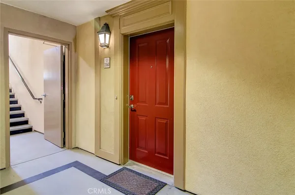 a view of a hallway with wooden floor and entryway