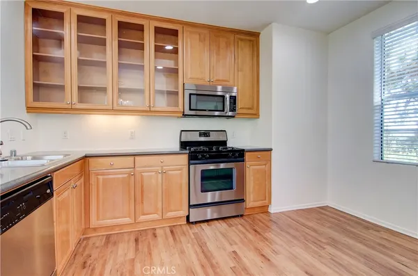 a kitchen with stainless steel appliances granite countertop a stove and a sink