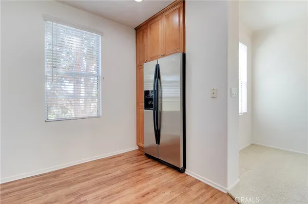 an empty room with wooden floor and a window