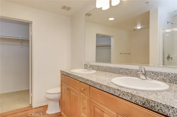 a bathroom with a granite countertop sink toilet and shower