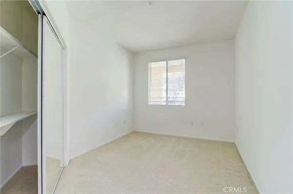 a view of an empty room with a closet