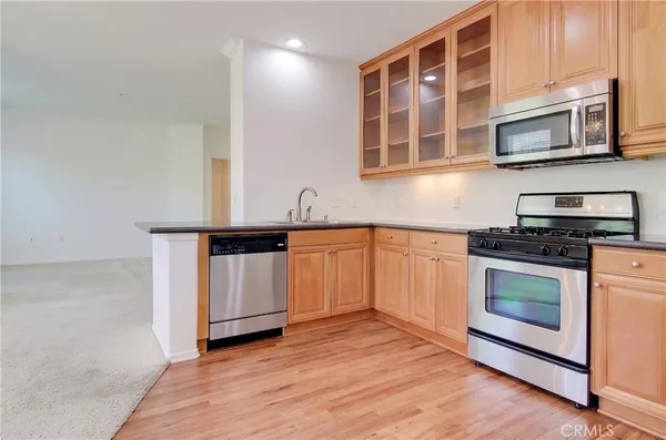 a kitchen with stainless steel appliances granite countertop a stove and a microwave