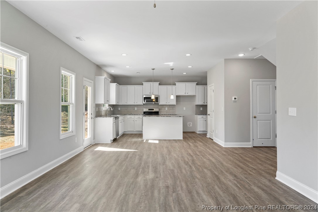254 Collier Street Linden, NC 28356 - Photo 14 of 34 a view of kitchen view wooden floor and window
