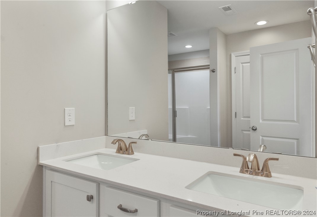 254 Collier Street Linden, NC 28356 - Photo 21 of 34 a bathroom with a sink and a mirror