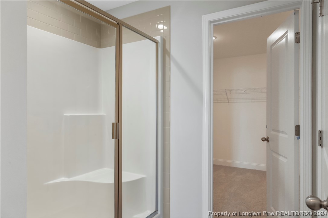 254 Collier Street Linden, NC 28356 - Photo 22 of 34 a bathroom with a glass shower door