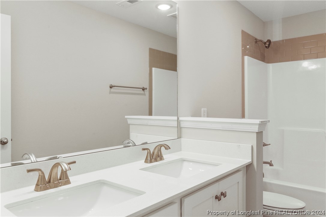 254 Collier Street Linden, NC 28356 - Photo 26 of 34 a bathroom with a sink and a mirror