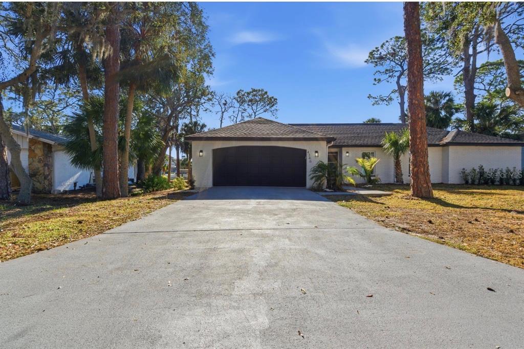 4346 Marine Parkway New Port Richey, FL 34652 - Photo 1 of 51 a front view of a house with a yard