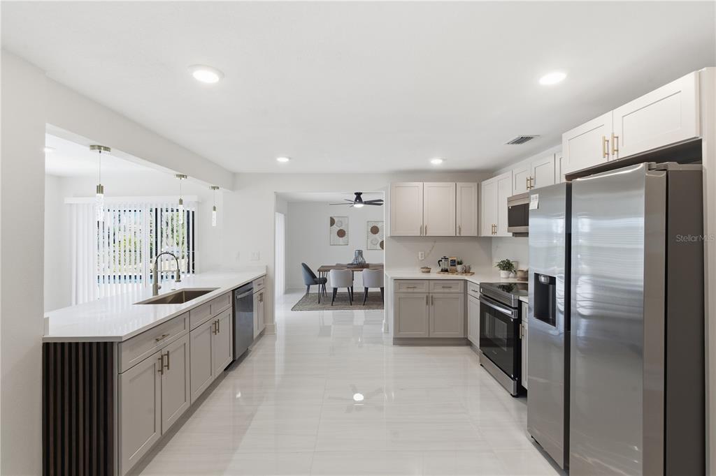 4346 Marine Parkway New Port Richey, FL 34652 - Photo 13 of 51 a kitchen with refrigerator and cabinets