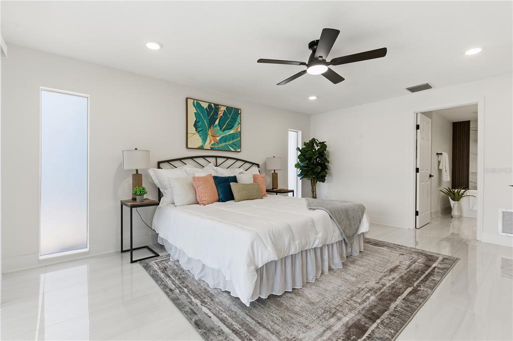 4346 Marine Parkway New Port Richey, FL 34652 - Photo 23 of 51 a bedroom with a bed and ceiling fan