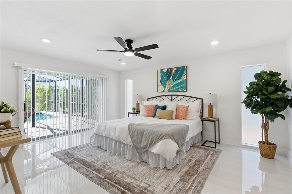 4346 Marine Parkway New Port Richey, FL 34652 - Photo 26 of 51 a bedroom with a large bed and a chandelier