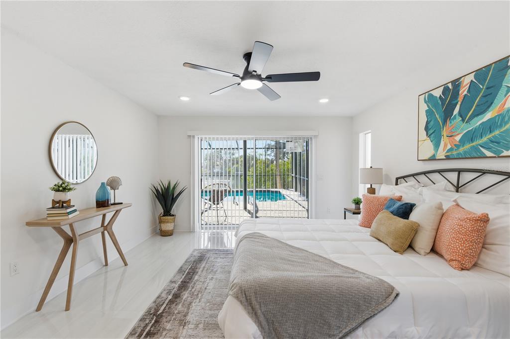 4346 Marine Parkway New Port Richey, FL 34652 - Photo 27 of 51 a bedroom with a bed a mirror and furniture