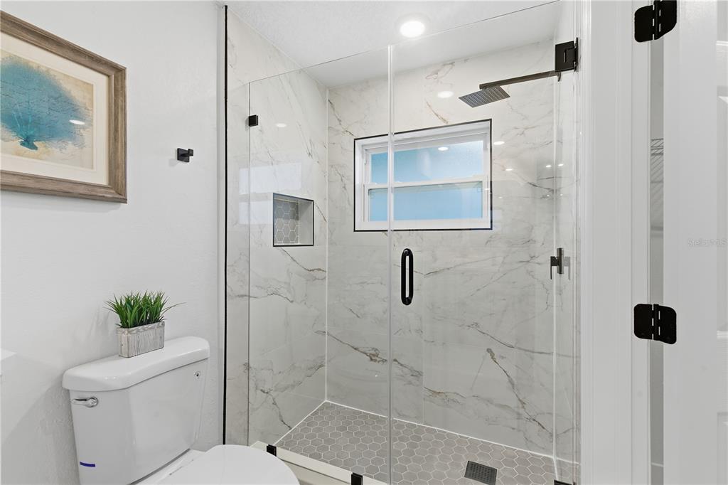 4346 Marine Parkway New Port Richey, FL 34652 - Photo 29 of 51 a bathroom with a shower toilet and a sink