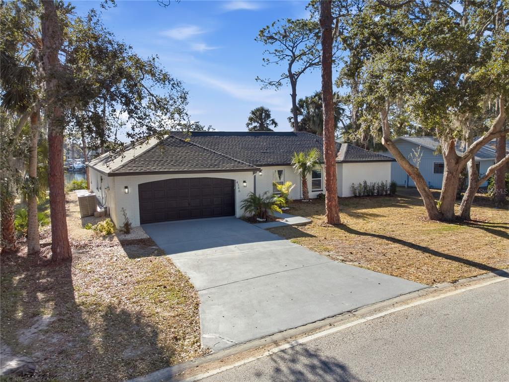 4346 Marine Parkway New Port Richey, FL 34652 - Photo 3 of 51 a front view of a house with a yard