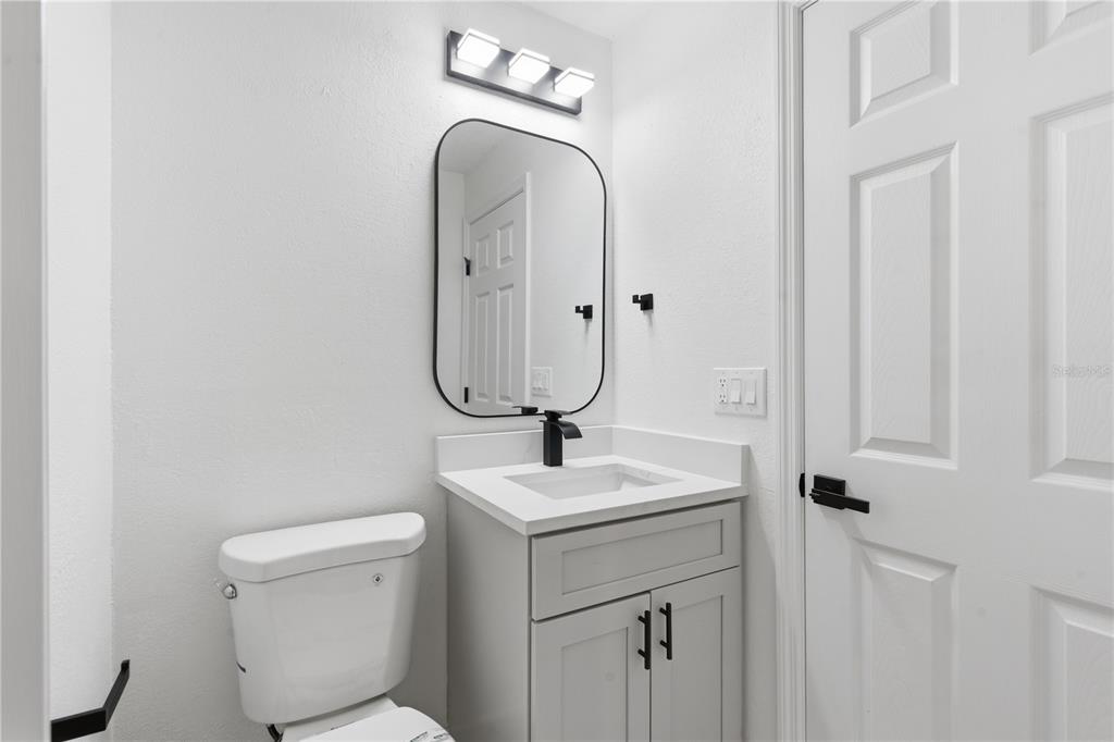 4346 Marine Parkway New Port Richey, FL 34652 - Photo 34 of 51 a bathroom with a toilet sink and mirror
