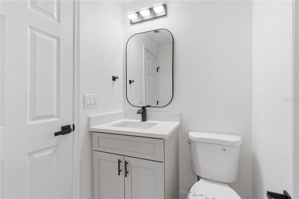 4346 Marine Parkway New Port Richey, FL 34652 - Photo 35 of 51 a bathroom with a toilet sink and mirror