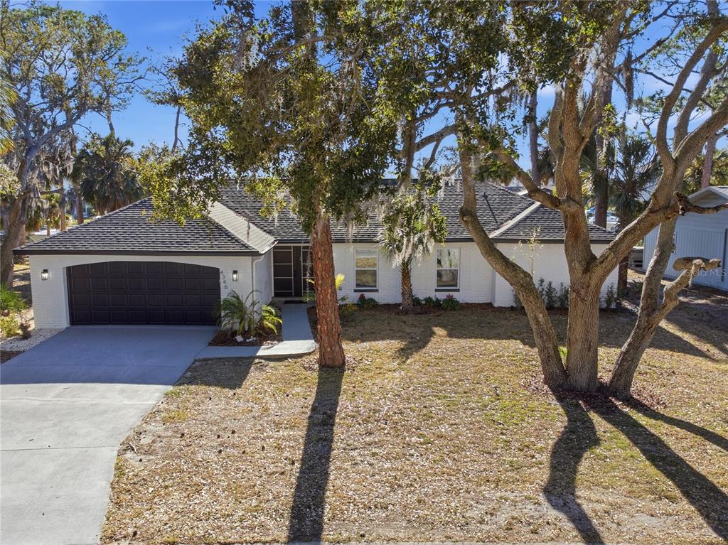 4346 Marine Parkway New Port Richey, FL 34652 - Photo 5 of 51 a house with trees in the background
