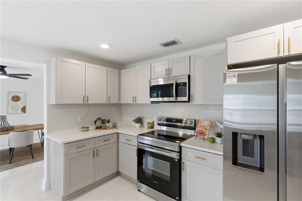 4346 Marine Parkway New Port Richey, FL 34652 - Photo 9 of 51 a kitchen with cabinets stainless steel appliances and sink
