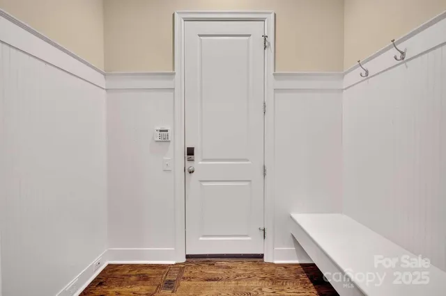 a view of a livingroom with wooden floor and a ceiling fan