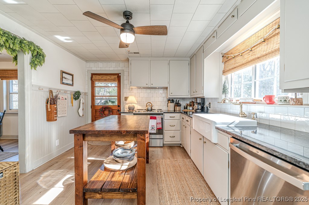 179 Sunset Hills Road Robbins, NC 27325 - Photo 11 of 31 a kitchen with stainless steel appliances kitchen island granite countertop a stove a sink and a refrigerator