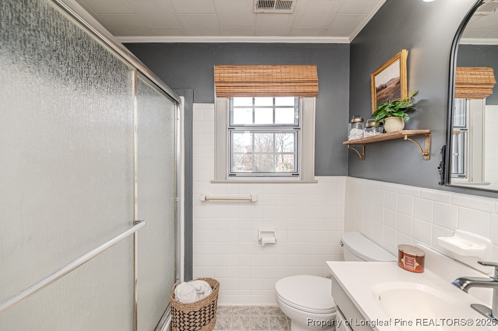 179 Sunset Hills Road Robbins, NC 27325 - Photo 20 of 31 a white toilet sitting next to a bathroom sink and a tub