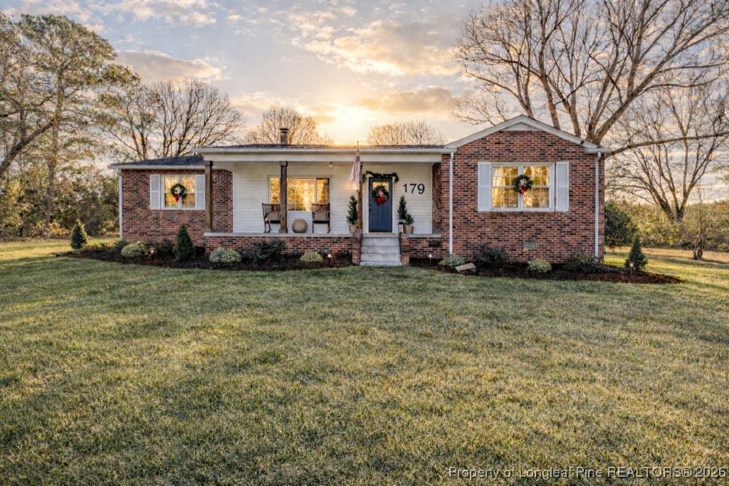 179 Sunset Hills Road Robbins, NC 27325 - Photo 2 of 31 a front view of a house with a garden and plants