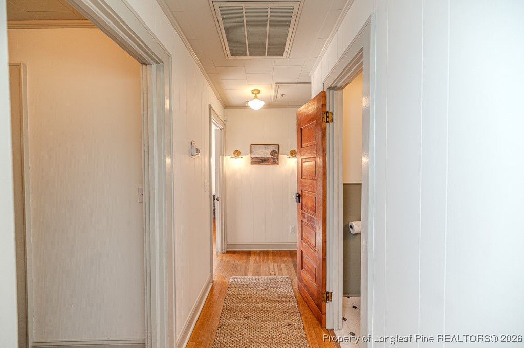179 Sunset Hills Road Robbins, NC 27325 - Photo 24 of 31 a view of a hallway with wooden floor and a bathroom