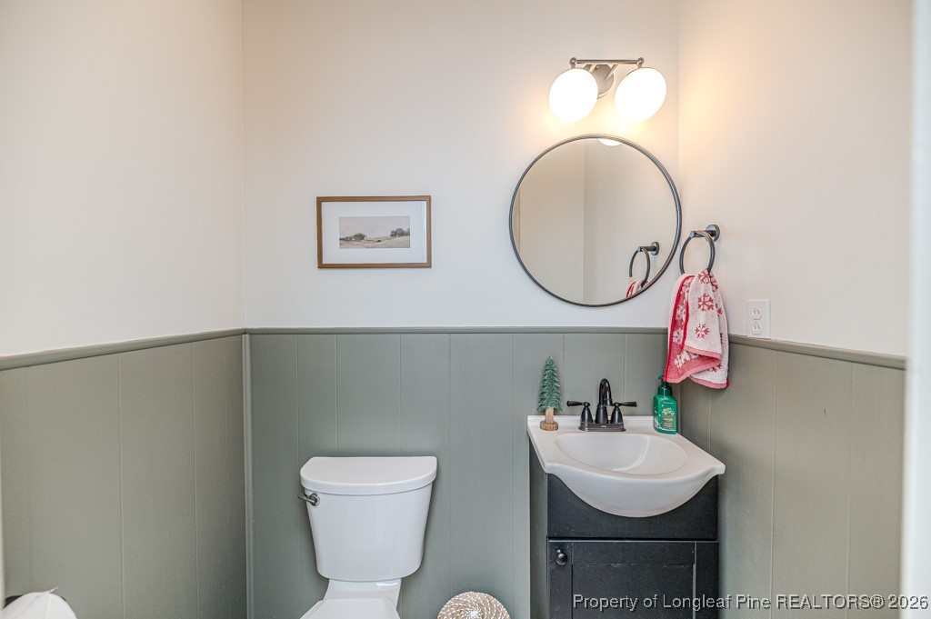 179 Sunset Hills Road Robbins, NC 27325 - Photo 28 of 31 a bathroom with a toilet a sink and a mirror