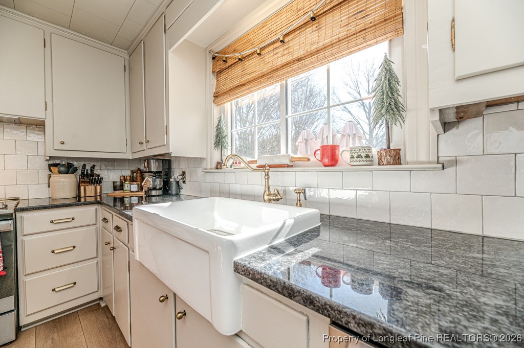 179 Sunset Hills Road Robbins, NC 27325 - Photo 9 of 31 a kitchen with granite countertop a sink a window and cabinets