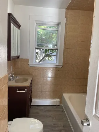 a bathroom with a sink a toilet and bathtub
