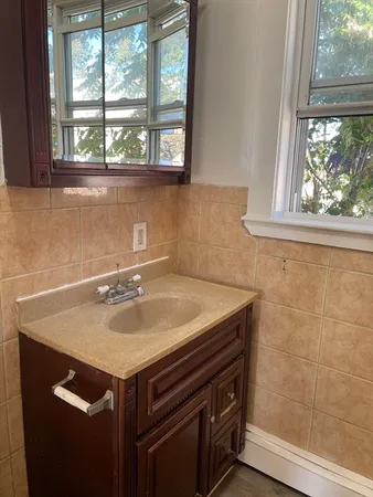a bathroom with a sink and a window