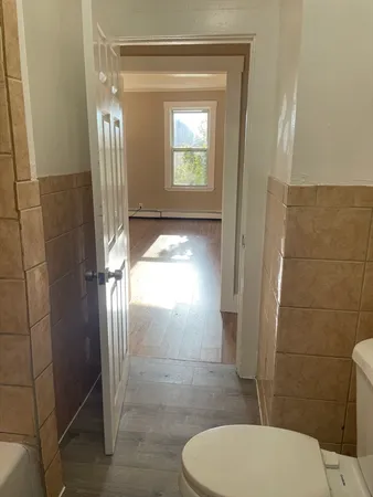 a bathroom with a toilet and a shower