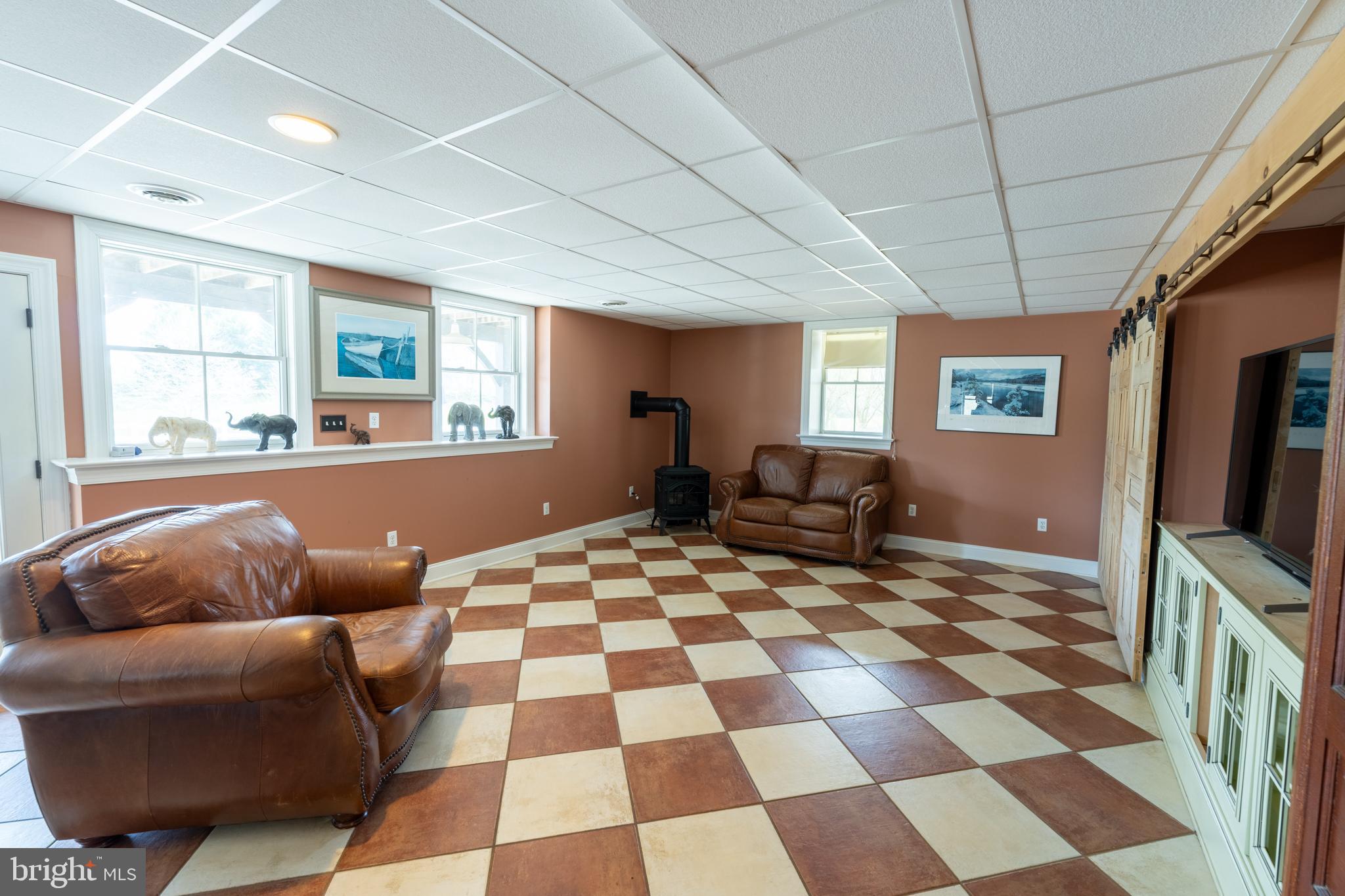 5727 Telegraph Road Elkton, MD 21921 - Photo 51 of 93 a living room with furniture and a black white checkered floor