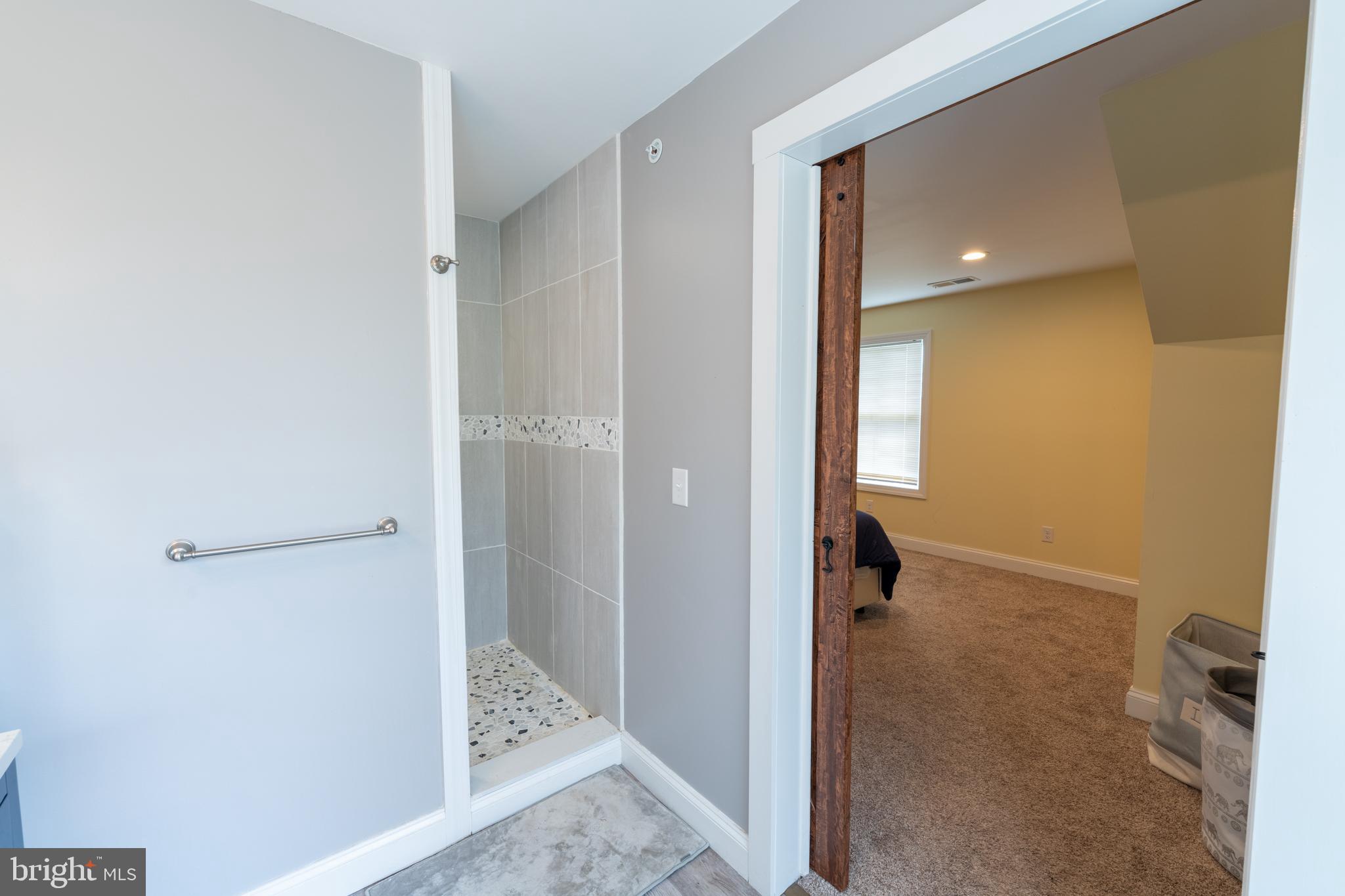 5727 Telegraph Road Elkton, MD 21921 - Photo 63 of 93 a view of a hallway with wooden floor and a bathroom