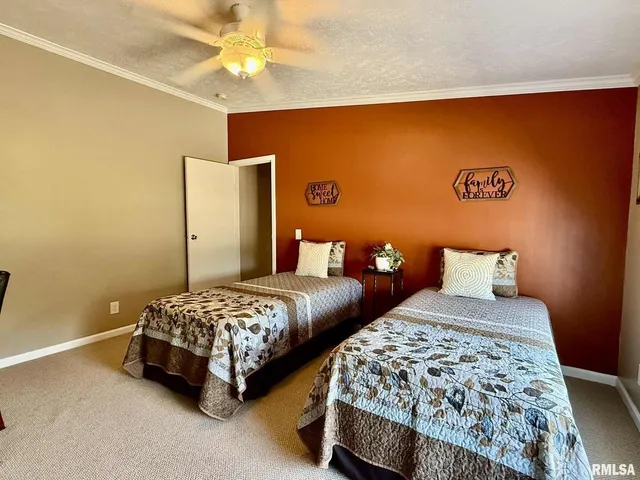 a living room with furniture a flat screen tv and gym equipment