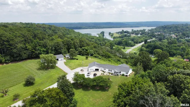 an aerial view of a houses with outdoor space and ocean view