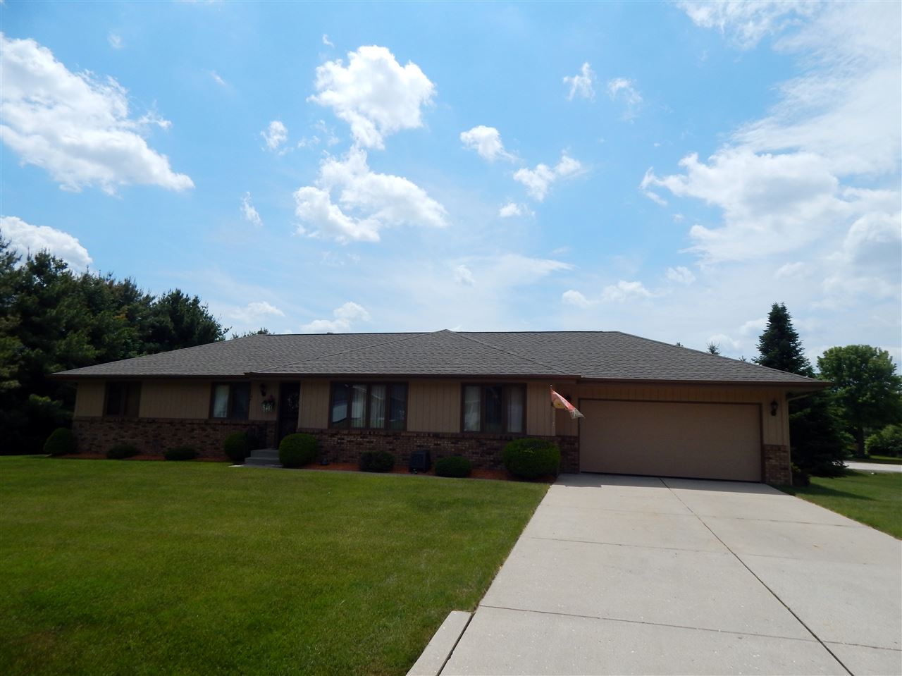 4259 Montclair Road Roscoe, IL 61073 - Photo 1 of 25 a front view of a house with a garden