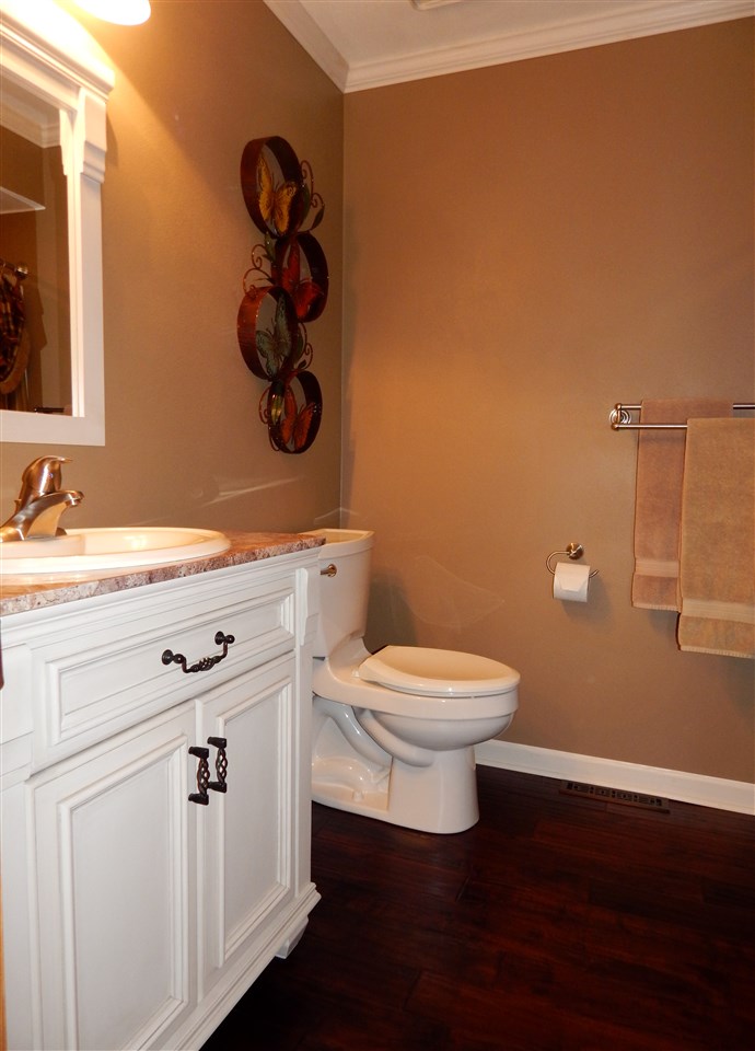 4259 Montclair Road Roscoe, IL 61073 - Photo 15 of 25 a bathroom with a toilet a sink and mirror