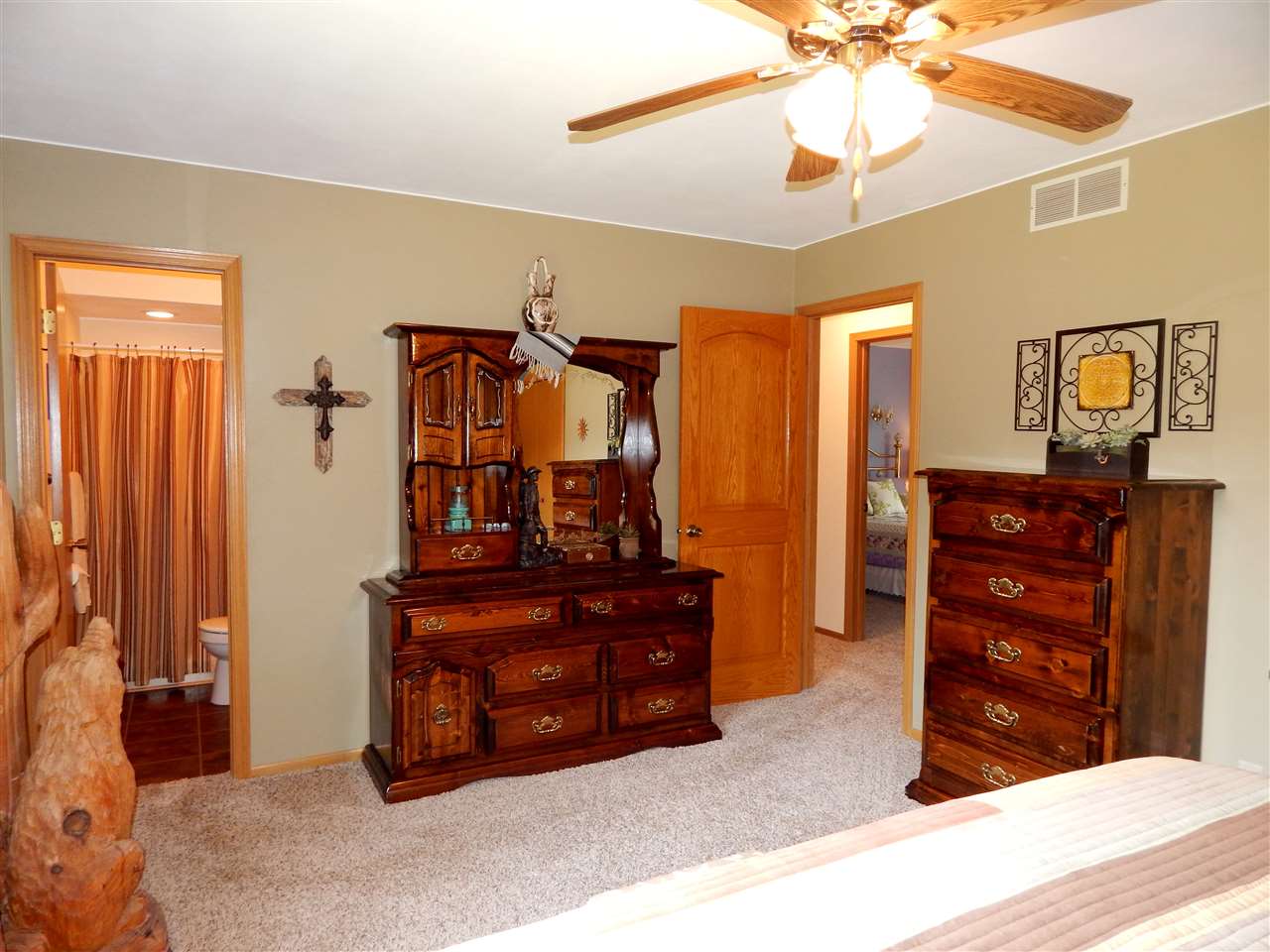4259 Montclair Road Roscoe, IL 61073 - Photo 20 of 25 a bedroom with a bed and a chandelier