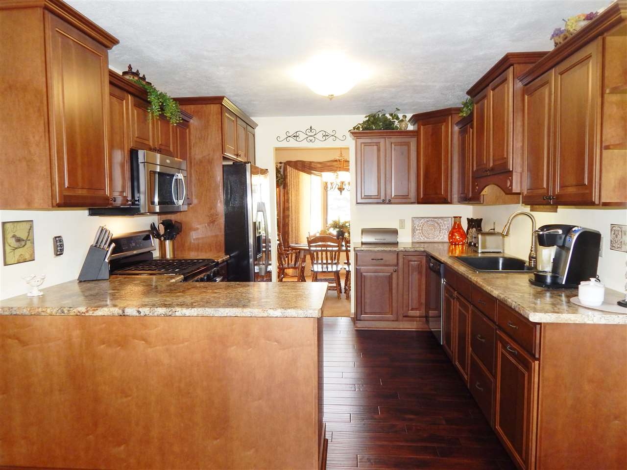 4259 Montclair Road Roscoe, IL 61073 - Photo 9 of 25 a kitchen with stainless steel appliances granite countertop a sink a stove top oven a counter space and cabinets