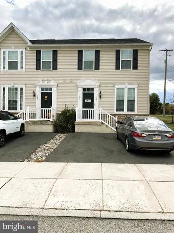 a couple of cars parked in front of a house