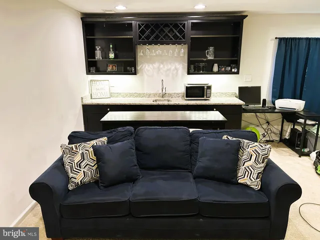 a living room with furniture and a lamp