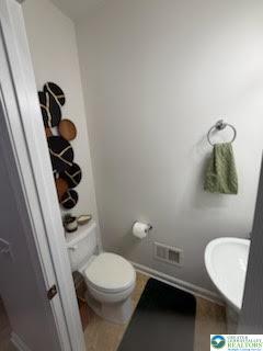 8514 Gateway Road Breinigsville, PA 18031 - Photo 11 of 23 a white toilet sitting next to a bathroom sink and vanity