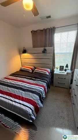 a bedroom with bed and window