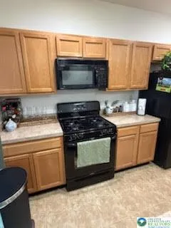a kitchen with a sink stove and microwave