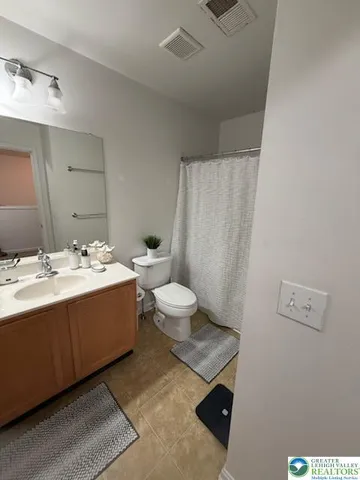a bathroom with a sink mirror and toilet