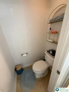 a white toilet sitting next to a shower