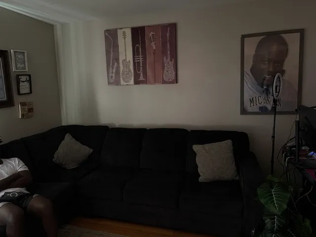 a living room with furniture and a lamp