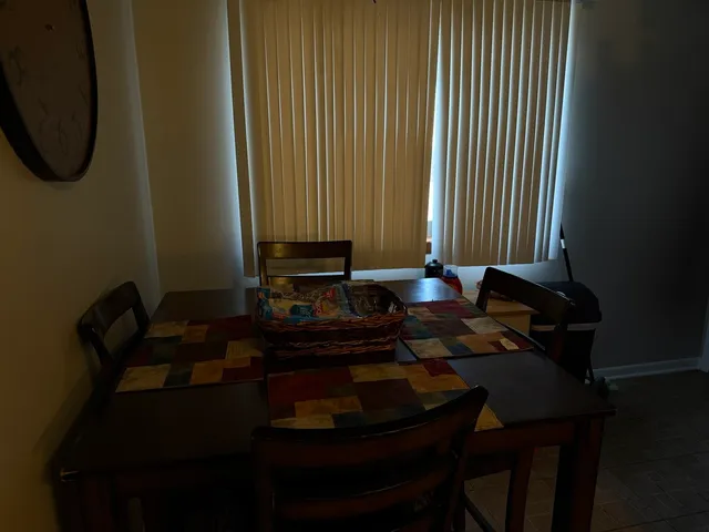 a table chair sitting in a living room next to a window