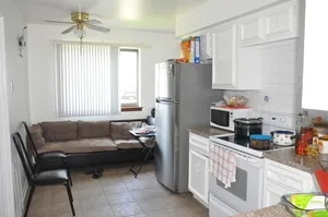 a living room with furniture a chandelier and a window